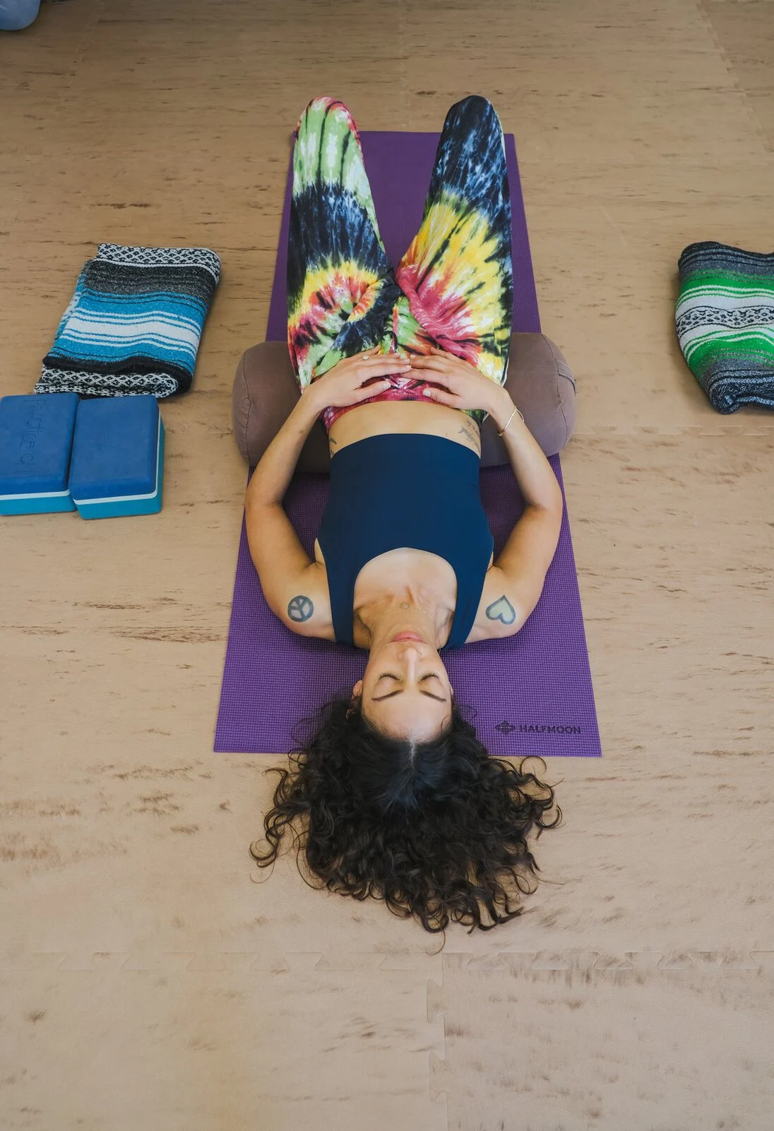 Resting on a bolster in a supported reclined pose